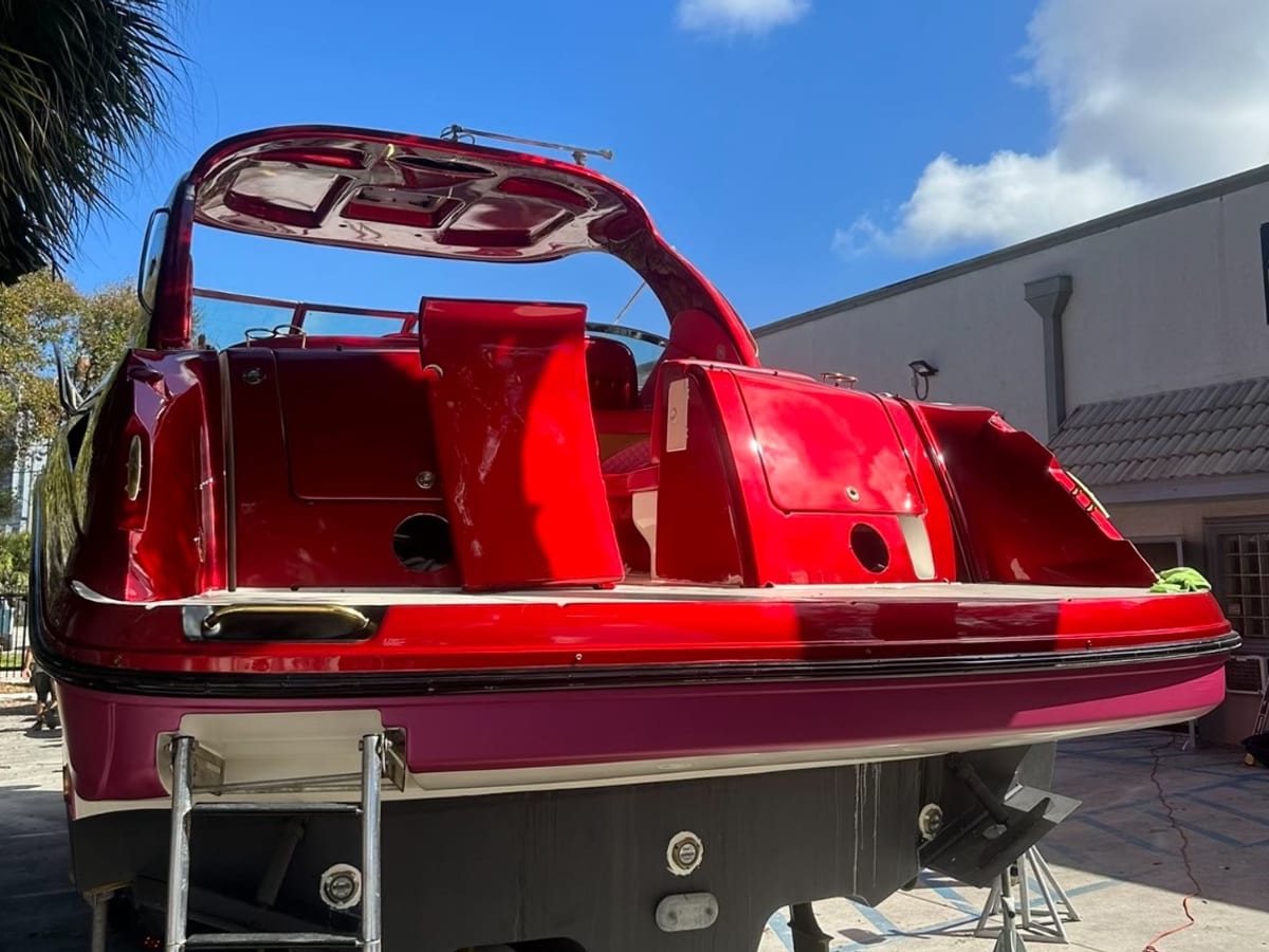 Stern and cockpit of a boat wrapped in red and pink